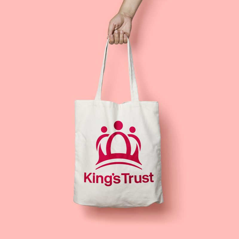 Branded merchandise kings trust tote bag with pink background.